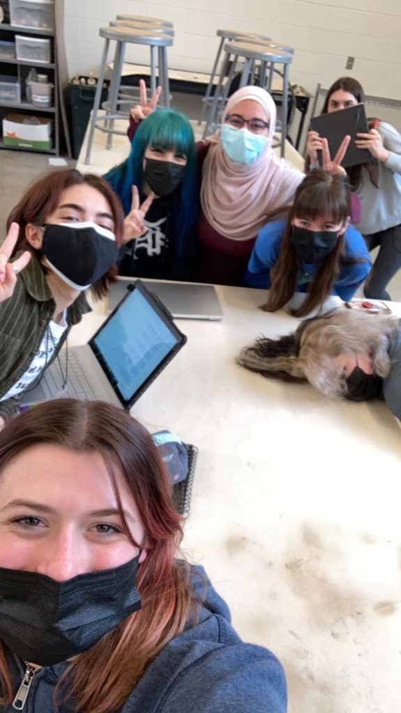 A picture of my friends and I, with me in the middle of the back in our ceramics room.