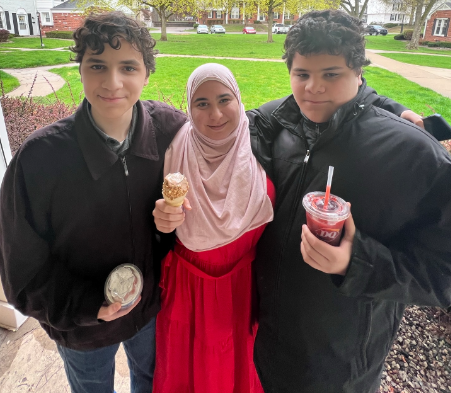 A picture of my brothers and I; I'm in the middle and my brothers to my sides, we're holding treats from Dairy Queen