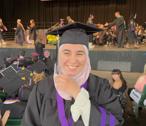 Another picture of high school graduation walking off the stage and laughing.
