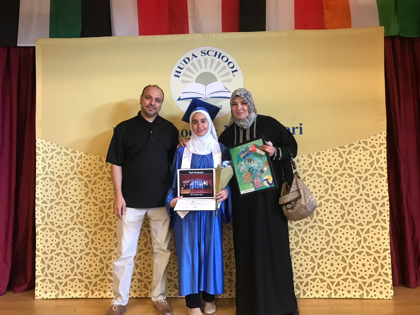 Picture of me and my parents during middle school graduation, my mother on the right and my father on the left. I'm in the middle holding my certificate and wearing a blue graduation gown.
